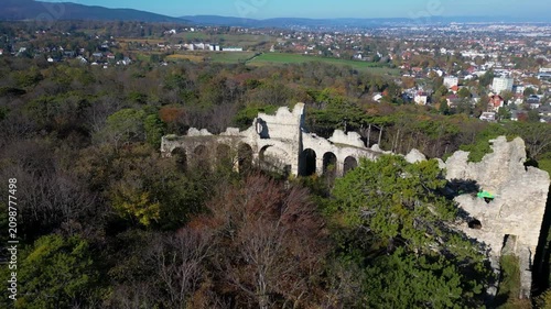 Aerial footage of the ruins of an ancient amphitheater hidden in trees, Austria