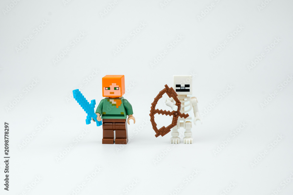 Obraz premium Two Minecraft-style block toy characters stand with a blue sword and brown bow on a white background. Suitable for pixel game toys, collectible figures on Apr 13, 2026 in Jakarta, Indonesia