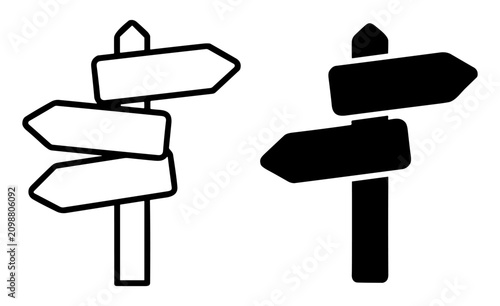 Photos Black and white signs with directional arrows on poles indicating multiple direc