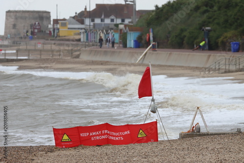 Red flag, signifying 'do not swim' , on beach at Clacton on Sea, Essex, UK