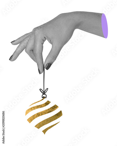 Surreal art collage with human hand holding a golden christmas tree ornament by a string on transparent background. Festive decor element, holiday magic and seasonal design