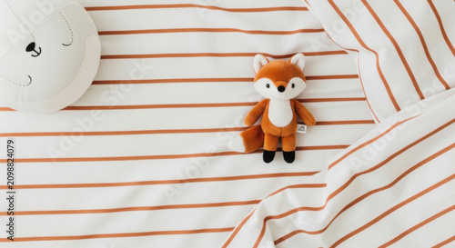 Cute Fox Plush Toy And Round Bear Pillow On Striped Bedding
