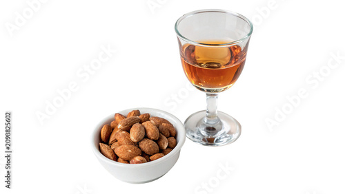 Фотография Glass of elite alcohol liquor drink with a side of snack nuts isolated on transp
