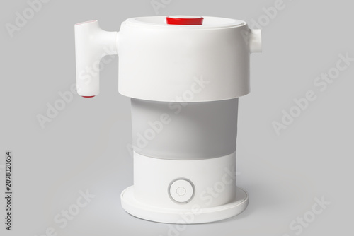 Obraz na płótnie Unfolded portable collapsible electric kettle with closed lid, side view