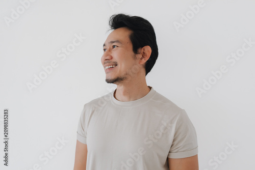 Принти на полотні Happy mid-adult Asian man smiling broadly and looking sideways on a clean white