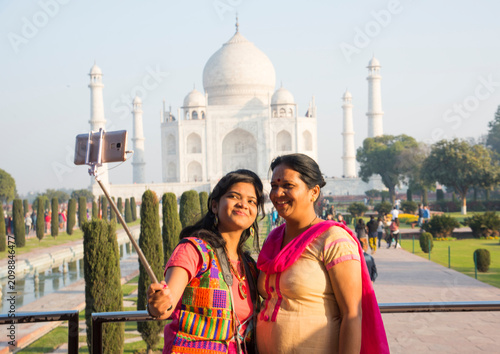 Indian mother and daughter in front of Taj Mahal.