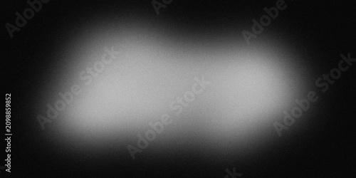 Konstfotografi Soft white circular glow surrounded by deep black textured background with grain effect