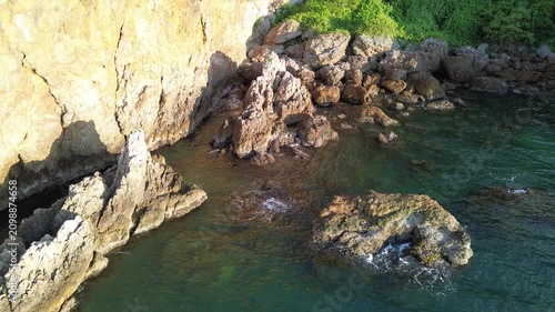 aerial view of sea waves crashing against rocky coastline
