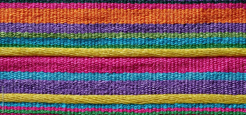 Obraz premium Bright horizontal stripes on a colorful woven textile, perfect for dynamic designs and eye-catching displays.