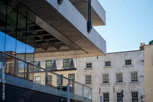 Canvastavla Modern cantilevered building meets historic city facades
