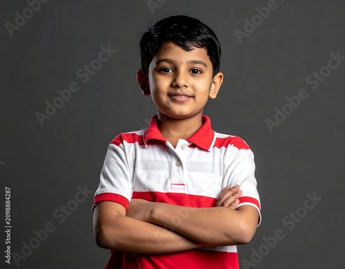 Young boy with arms crossed, confident pose