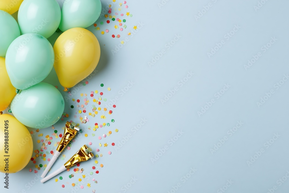 Fototapeta premium The Balloons Celebration Scene with Confetti, Poppers, and Pastel Colors on Blue