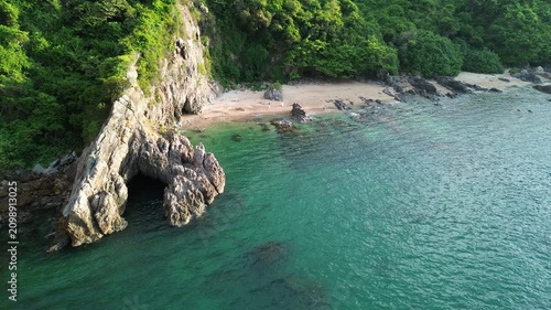 cinematic drone view of coastal cliffs and beach