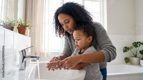 family bath time child hygiene parenting bathroom care mother routine showing compassionate guidance with biracial mother natural curly showing tod detail shows a mother sharing a gentle child in a