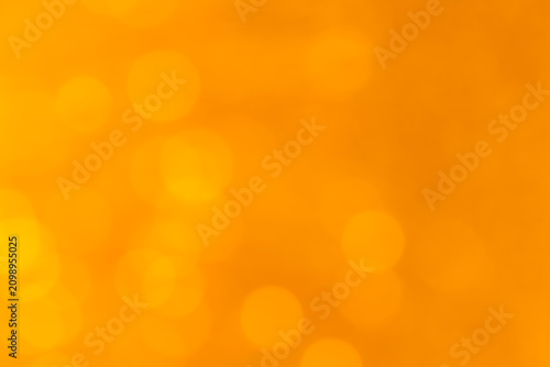 Abstract warm golden bokeh lights background with soft yellow glow