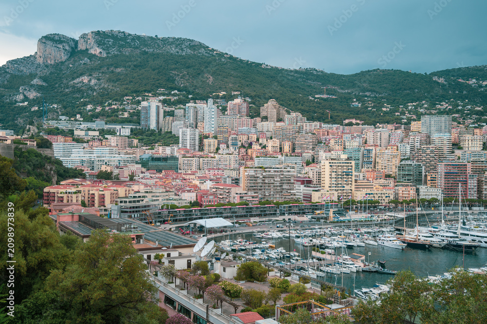 Obraz premium Exclusive real estate development and luxury hillside residential apartments overlooking Port Hercules in Monte Carlo, Monaco