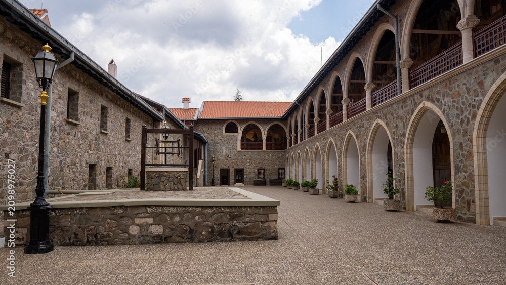 Fototapeta premium Stone courtyard surrounded by arched walkways