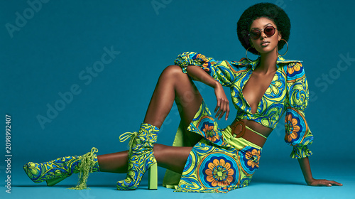 retro black woman in colorful seventies fashion, glamorous africanamerican model in vibrant vintage style, stylish woman wearing colorful retro inspired outfit