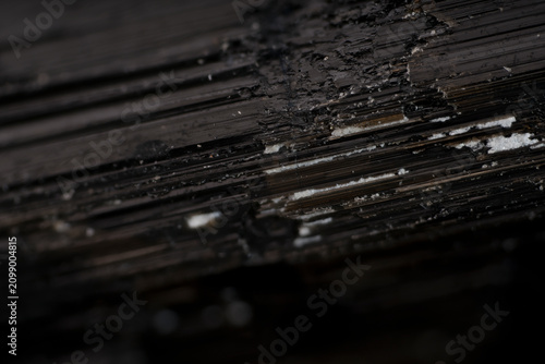 Fotografie Black schorl tourmaline crystal vertical micro fault healed with secondary miner