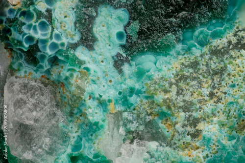 Mint green malachite spherulites with yellow limonite oxidation zone and quartz documentary scientific microphotography, detailed mineral texture shot captured through microscope lens