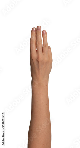 Female hand raises three fingers upward in a row. Gesture suggests counting or showing the number