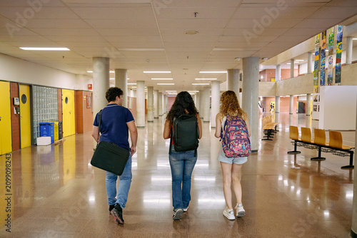 University students walking in educational facility hallway