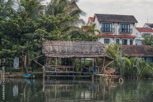 Rustic Thatched Roof Shelter Over a Peaceful River