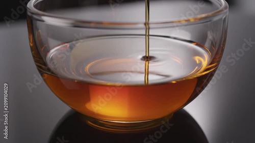 Oil is poured into a clear bowl for cooking and preparing food at home