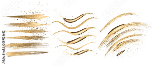 Golden brush strokes. Glittering abstract lines.