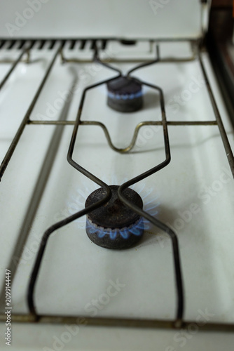фотографія Gas stove with blue flame, the concept of energy crisis and lack of heating and