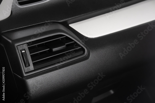 Картината върху платно Car air vent close up on a modern vehicle dashboard featuring an interior air conditioning vent and climate control system