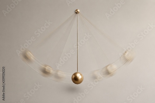 Pendulum swinging in arc trajectory, minimalist timekeeping concept with motion blur.