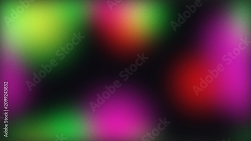 Abstract blurry background with soft glowing green red and purple light shapes