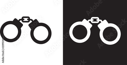 Foto Handcuffs silhouette in black and white against a contrasting background represe