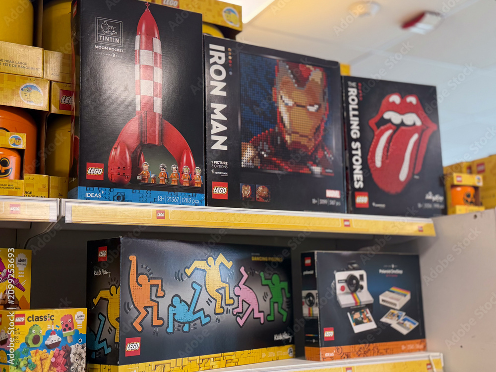 Fototapeta premium Lego boxes with iron man, rocket and music themed sets on store shelves