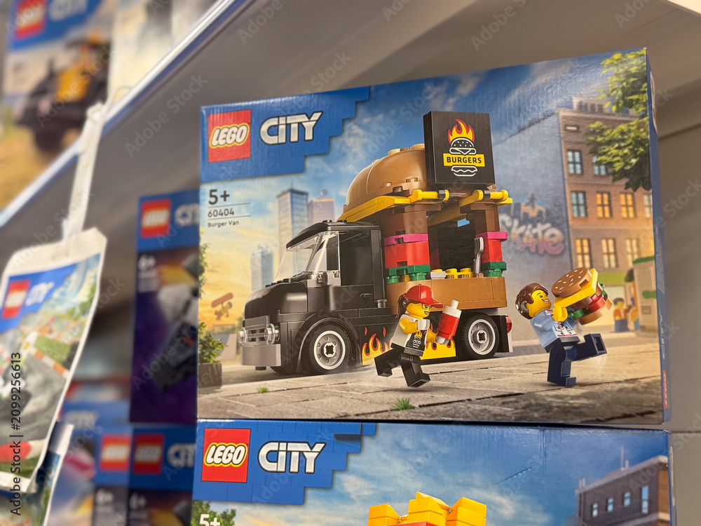 Fototapeta premium Lego city toy box displayed on a retail shelf in a store, showing a delivery truck playset and colorful packaging.