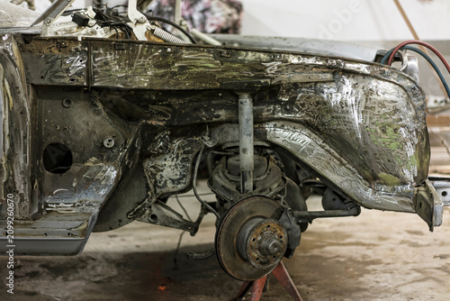 Stripped Bare Metal Car Chassis and Front Suspension under Restoration