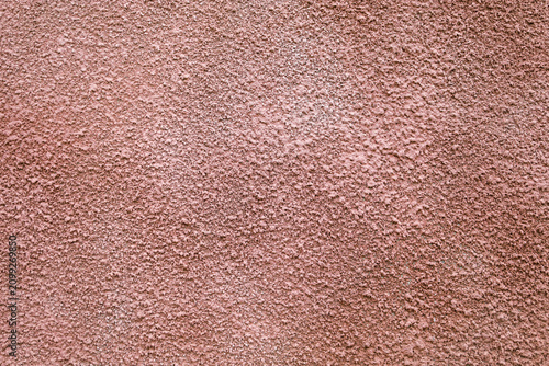 Obraz na płótnie A rough texture of decorative plaster in a brown-pink hue on a building wall