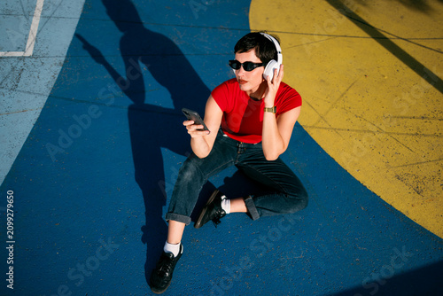 Woman enjoying music on smartphone and headphones