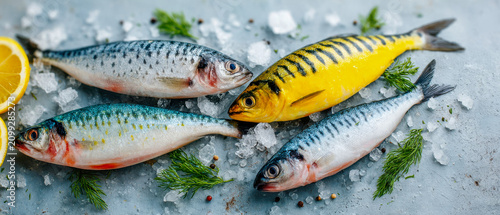 Different kinds of fish placed on ice with lemon slices and herbs in a kitchen setting during the day