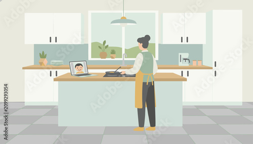 Young woman cooks food in a modern bright apartment kitchen while chatting with a kid via video call on her laptop.