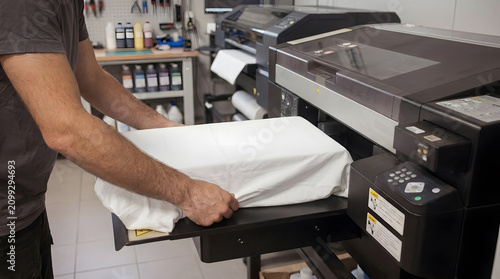 Operator Placing White T Shirt inside DTG Printing Machine | Direct to Garment Printing Process on Fabric in Workshop | Worker Preparing Textile for Digital Custom Apparel Print 