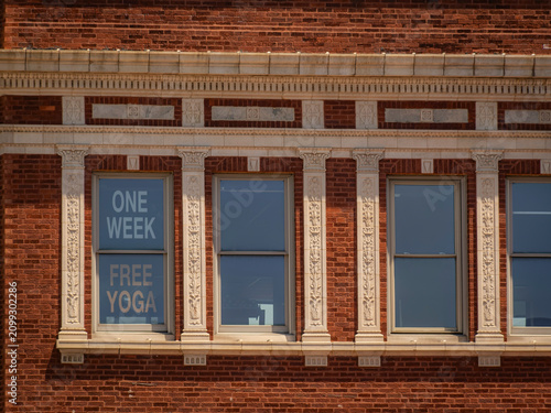 Fotografía Historic red brick facade with ornate white trim pilasters and window advertisin