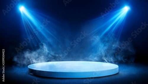 blue stage lights illuminating round platform with smoke effect