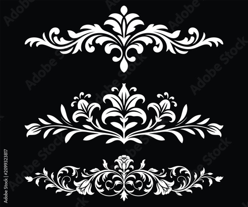 White floral ornamental border design elements with lilies on black background flourish.