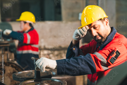 Construction worker hard hat safety glove industrial site factory uniform machine gear maintenance laborer sweating and working with equipment in workshop scene