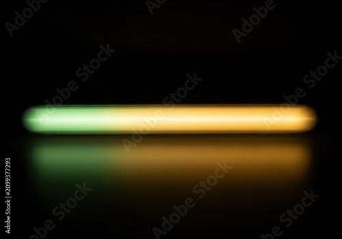Abstract glowing horizontal light bar with green and yellow gradient