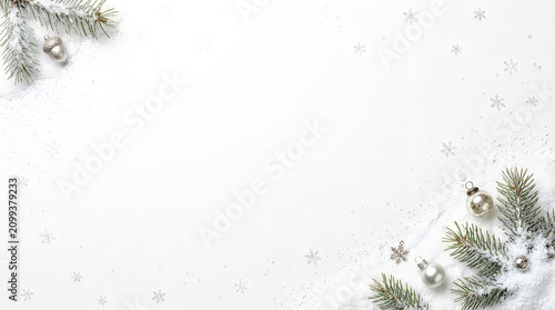 Christmas ornaments and pine branches with snow on a winter holiday background