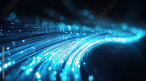 Fiber cable curves with flowing light trails captured through long exposure photography showing electric blue cyan illumination in dark space