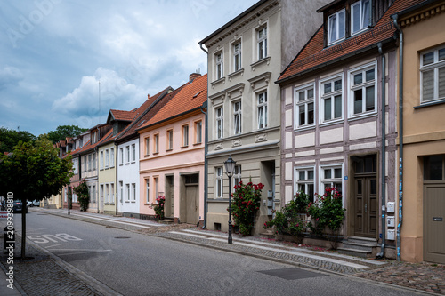 Historic pastel houses with blooming roses – Altstadt Rosenstraße I, Wittstock, Brandenburg, Germany